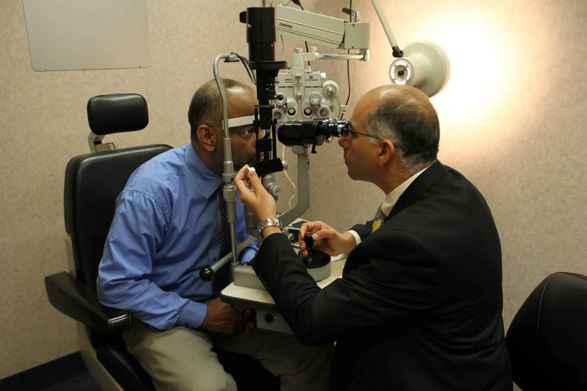 Dr. Moussa conducting an eye exam on a patient